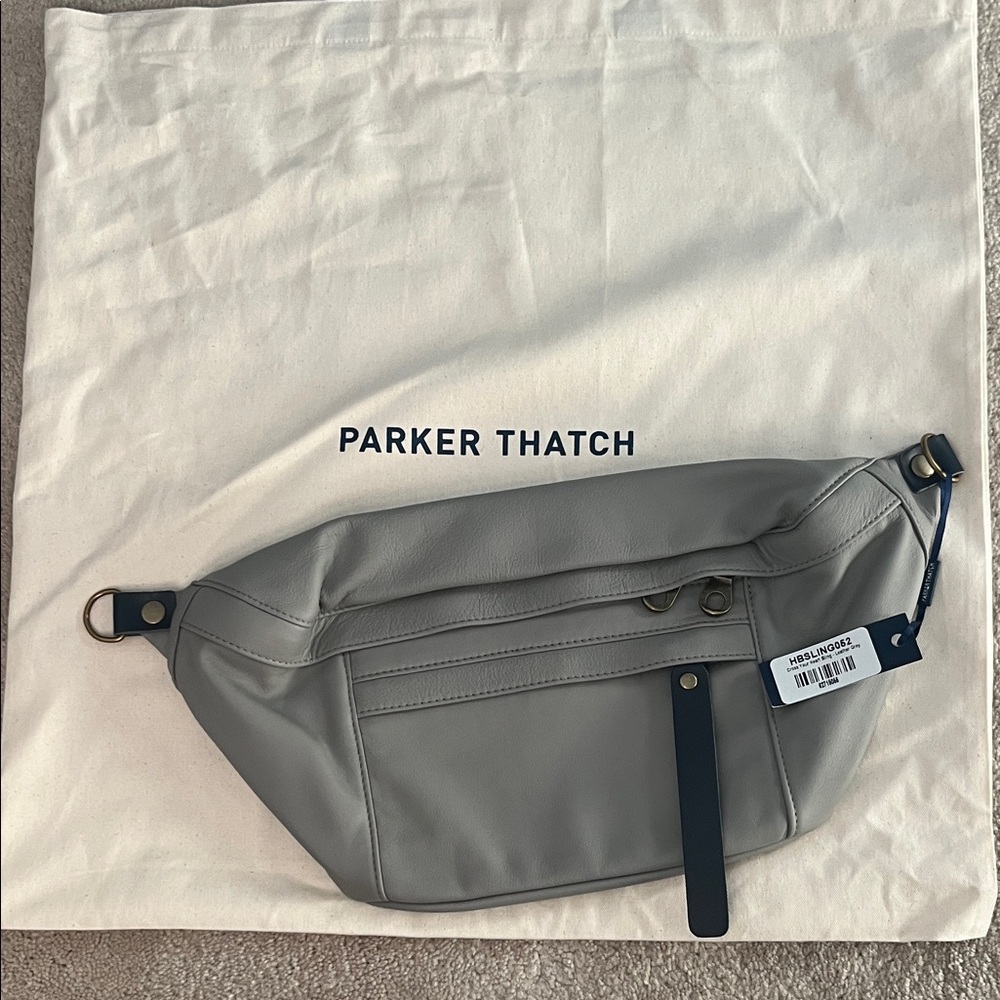 NWT Cross your heart sling bag.  Beautiful gray with navy blue accents.